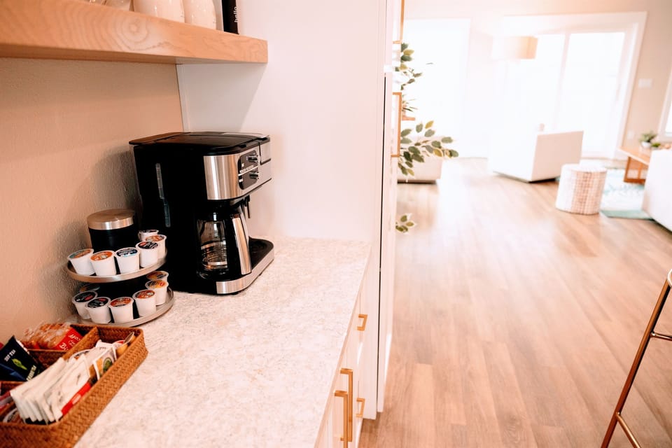 Coffee bar, includes Nespresso machine and milk frother.