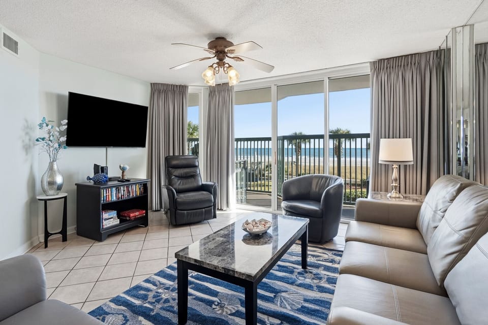 Open living area with a wall-mounted TV and beach views at Ashworth 105 in Ocean Drive, North Myrtle Beach