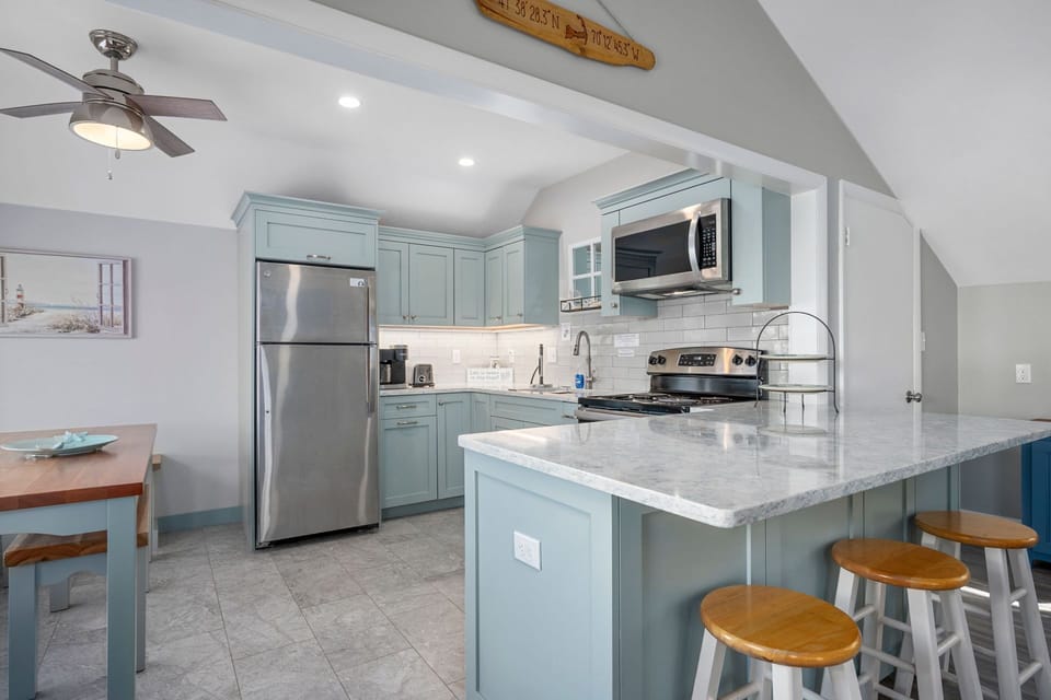 Kitchen with full size fridge, stove/oven and microwave