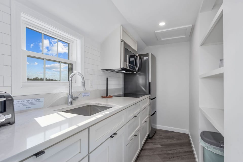 Kitchen with  fridge, stove and microwave
