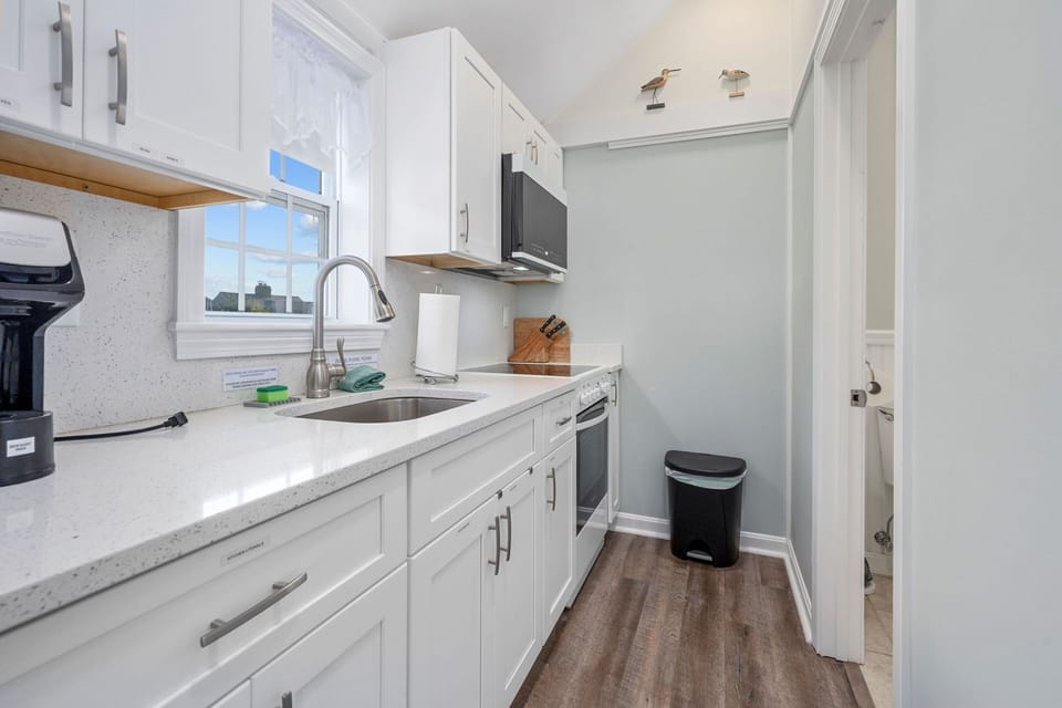Kitchen with stove, fridge and microwave