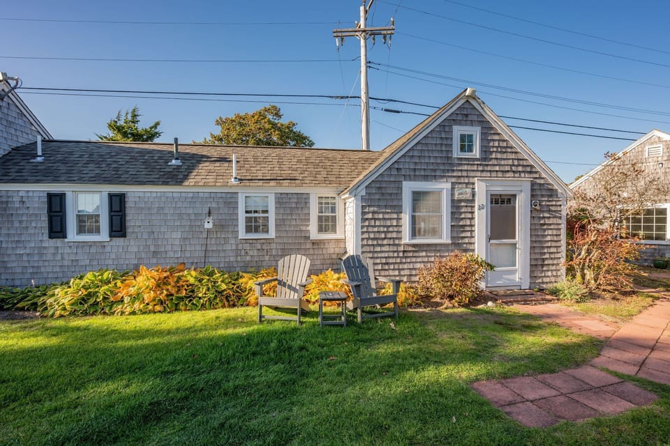 Seating area in front of cottage with view of the lawn