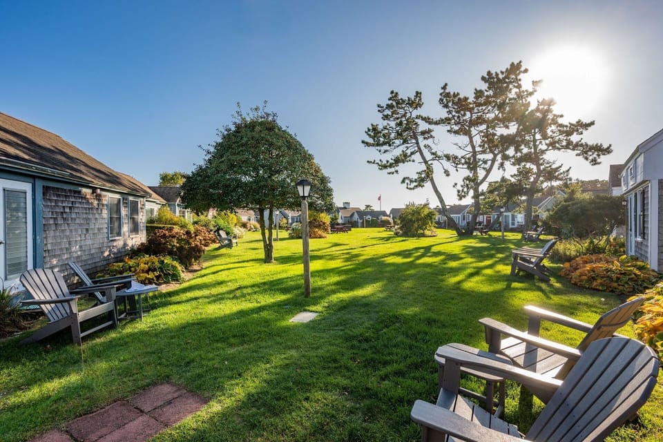 Seating area in front of cottage with view of the lawn