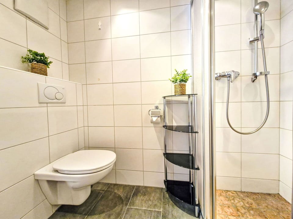 Flooring, Interior Design, Plumbing Fixture, Bathroom, Toilet, Floor, Toilet Seat, Plumbing, Room, Tile