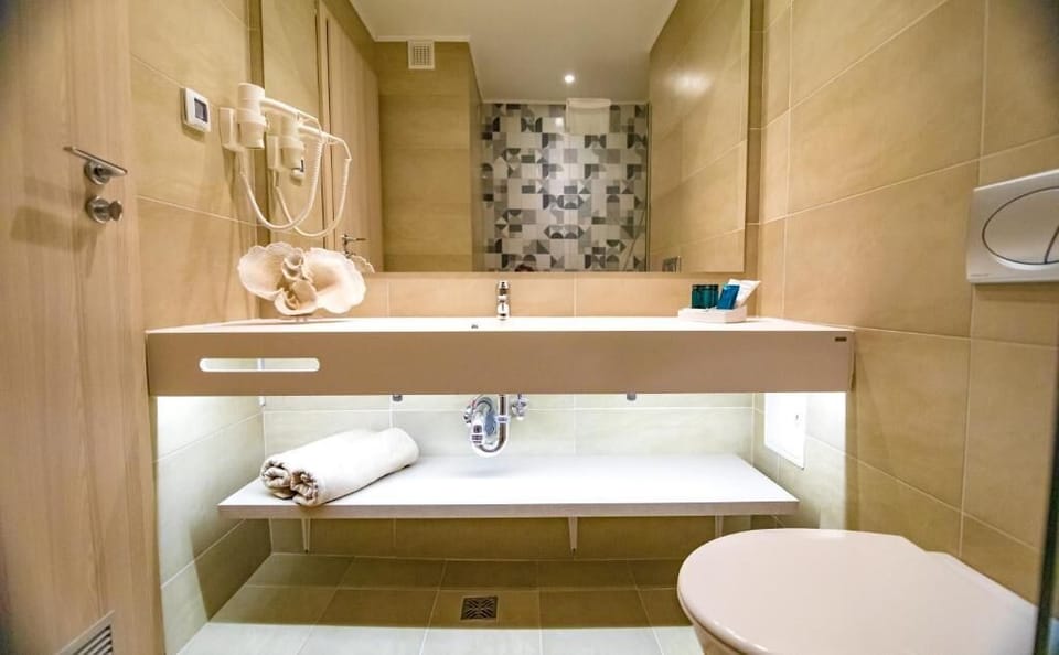 Deluxe Triple Room, Balcony | Bathroom | Shower, hair dryer, slippers, towels