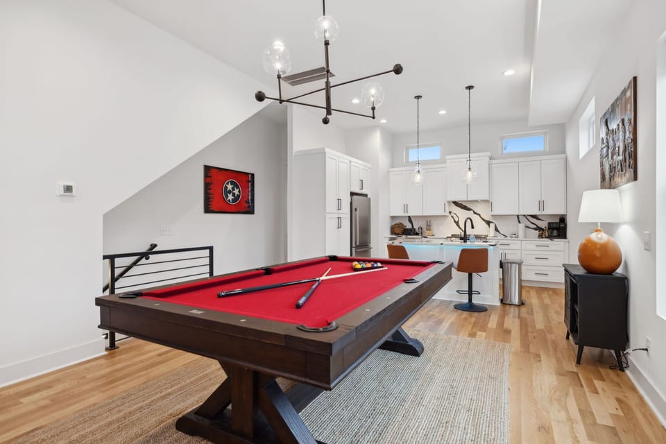 Living Room: This inviting space includes a red pool table, large sectional, and modern design elements for the perfect mix of fun and comfort.
