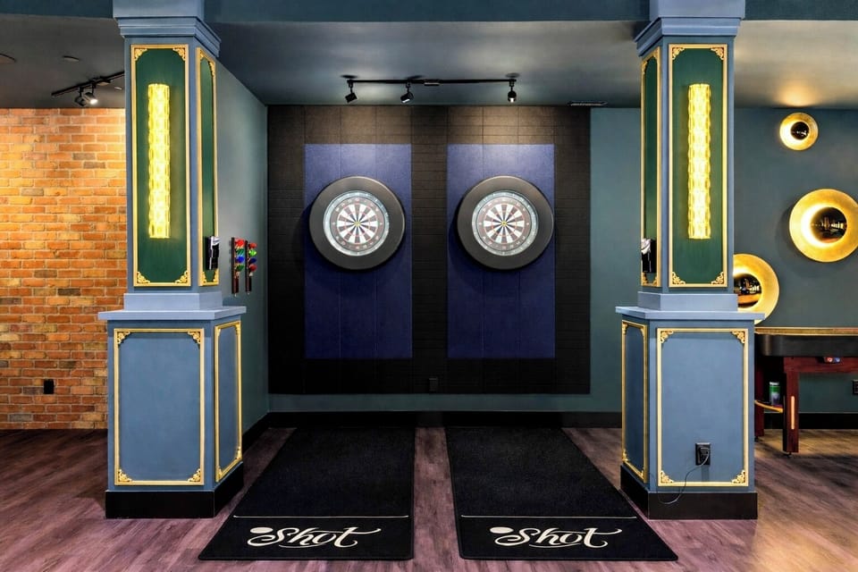 Two dart boards, exposed brick, and custom lighting make this the room your group never wants to leave