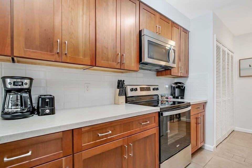 Fully equipped kitchen with fridge, stove, oven, microwave, dishwasher, blender, toaster, drip coffee maker, and Keurig – everything you need for a Butler Beach week.
