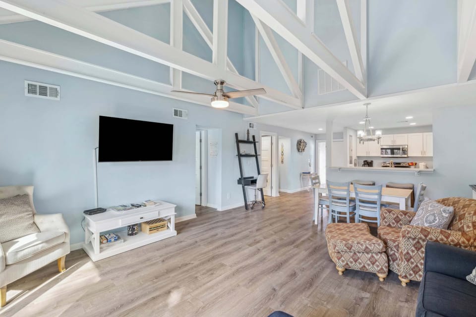 Bright living space with ample seating, deck access, and TV