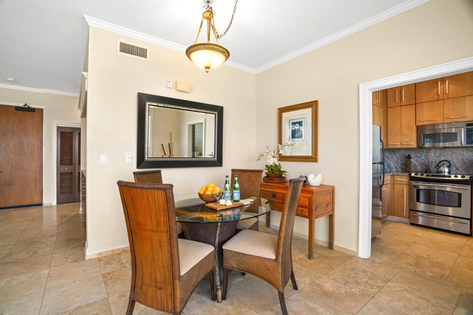 Elegant dining area adjoins a sleek kitchen in a beautifully lit open plan