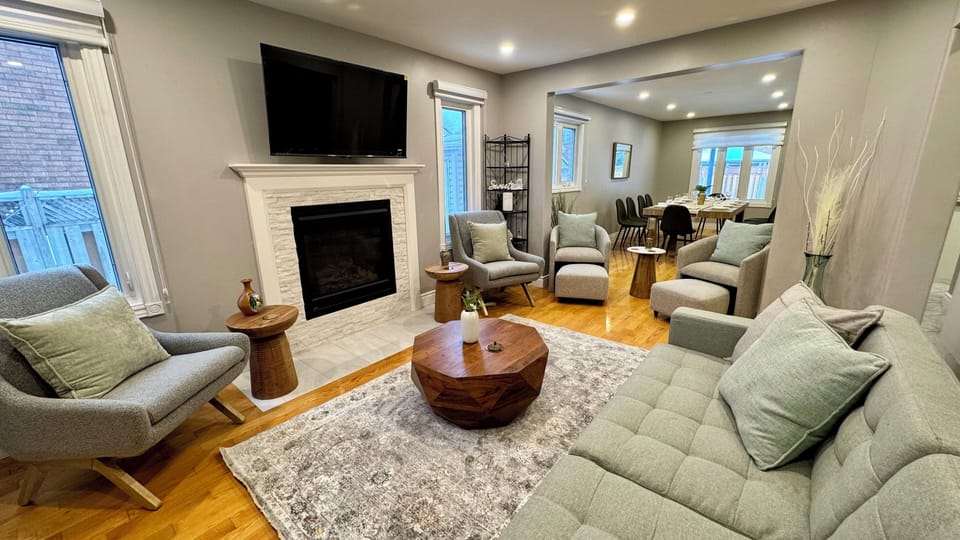 Living room with sofa bed, smart TV, and gas fireplace