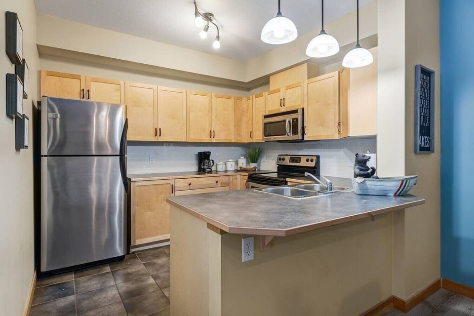 Fully equipped kitchen with stainless steel appliances.