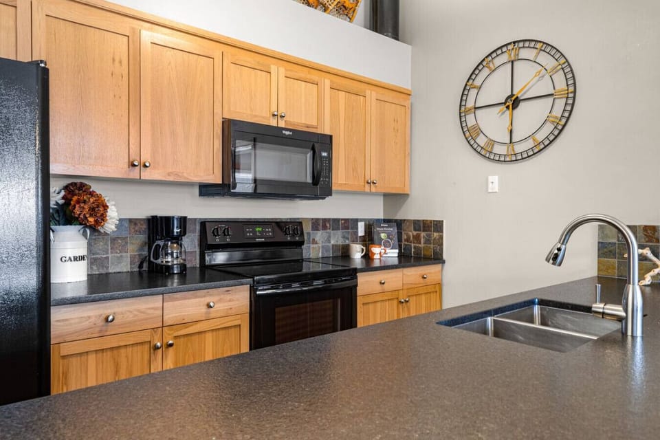 Full kitchen with all essentials such as microwave, fridge, stove, cooking utensils, coffee maker, etc.