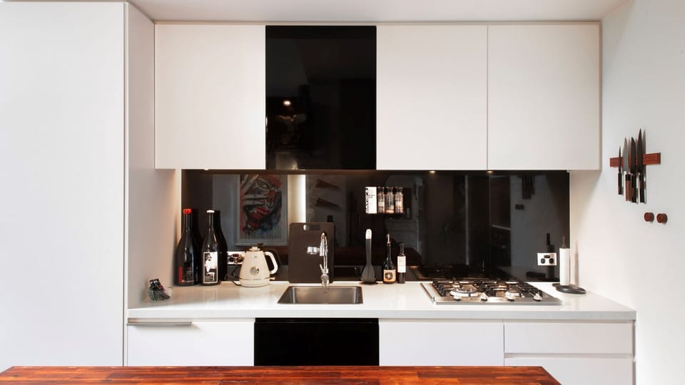 Prepare meals in this beautifully designed, modern kitchen with sleek lines and high-end finishes.