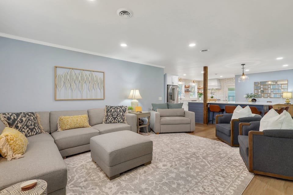 Living room with a sectional couch and three armchairs