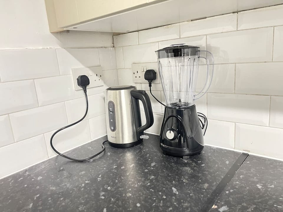 The spacious kitchen combines contemporary style with functionality, offering a large island, ample storage, and a bright, welcoming atmosphere.