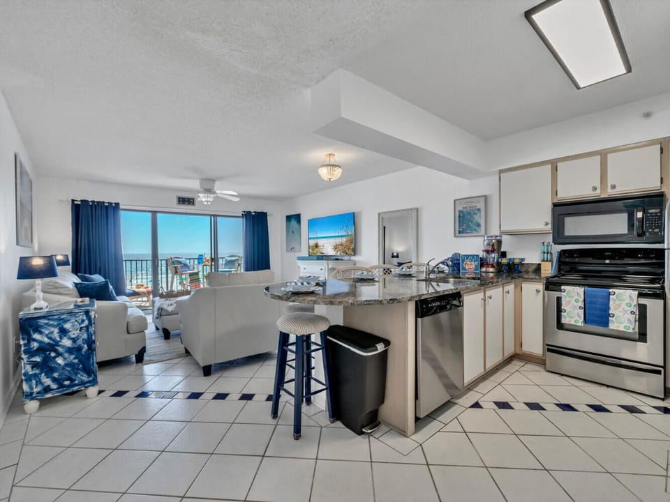 Your bright, open-concept space flows seamlessly from kitchen to living room, with stunning Gulf views framing your beachside getaway through expansive windows.