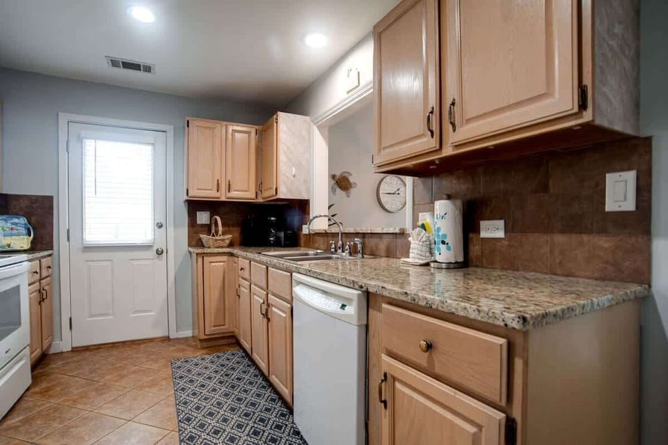 Your fully equipped kitchen features granite counters, warm wood cabinets, and everything you need to prepare delicious home-cooked meals during your stay.