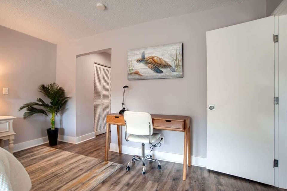 Your dedicated workspace features a warm wooden desk and ergonomic chair, perfect for staying productive during your stay.