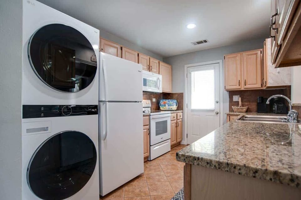 Your fully-equipped kitchen features granite countertops, modern appliances, and convenient in-unit washer and dryer for ultimate comfort.