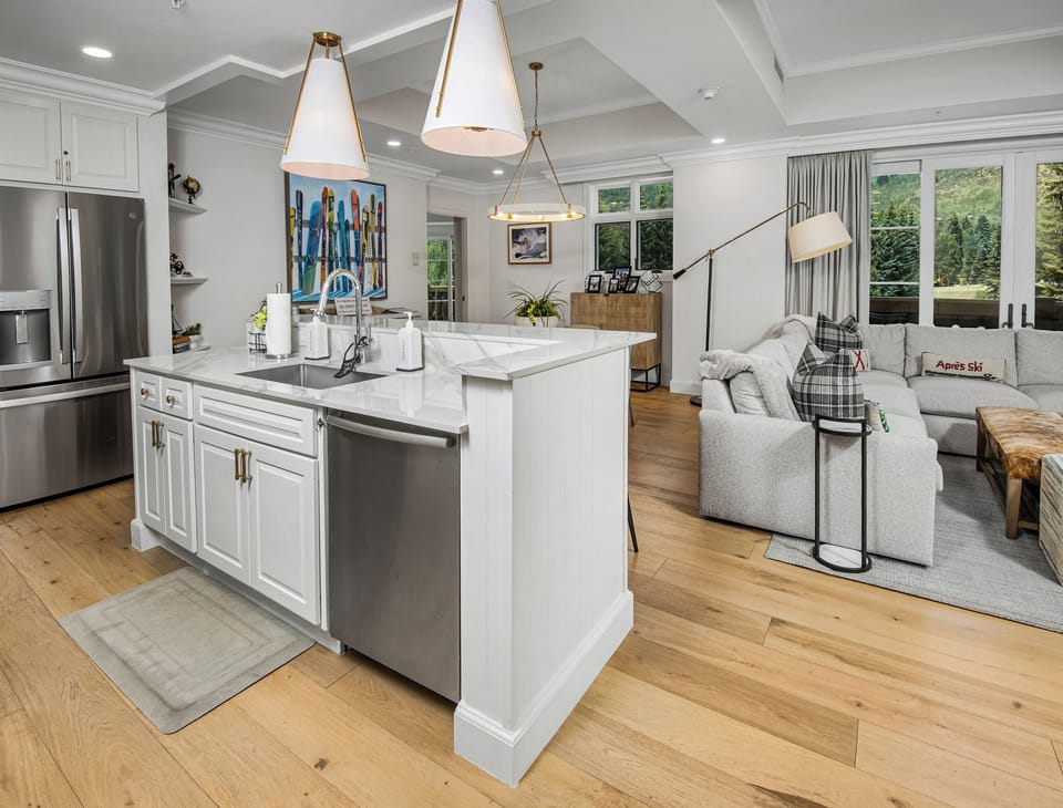 Your bright, open-concept living awaits, where chef-worthy countertops meet a cozy lounge framed by natural light and modern elegance for effortless entertaining.