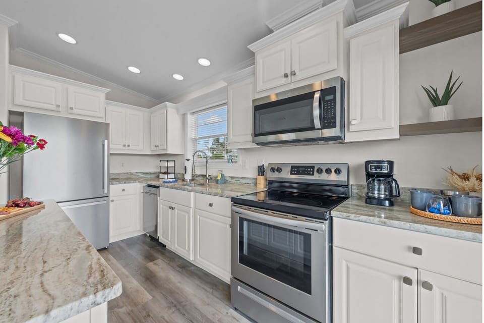 Sunlit space with modern appliances and a spacious island for memorable meals!