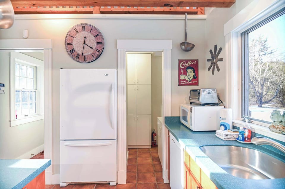 The airy kitchen offers ample space & all the comforts of home