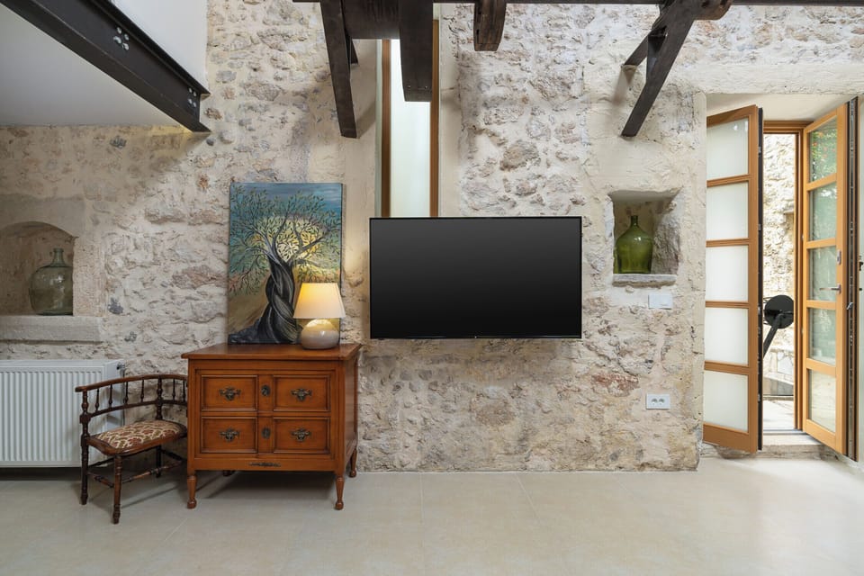 Deluxe Villa, Pool View | Living area | Flat-screen TV, fireplace