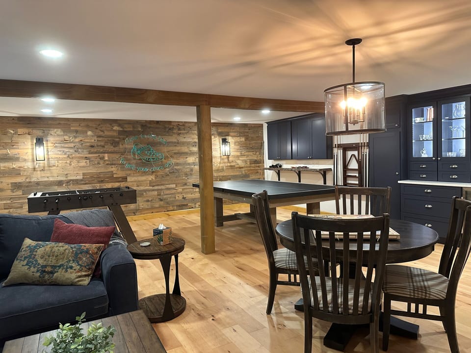 Game room with pool/ping pong table, foosball table and games.