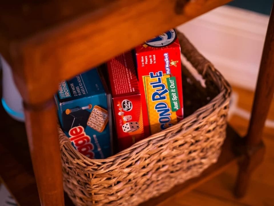Woven basket stocked w/ games, ready for cozy nights in