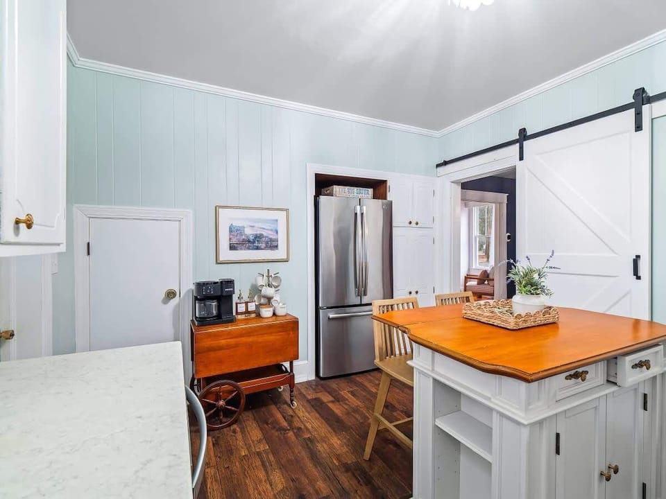Airy kitchen w/ modern finishes & island seating for everyday meals