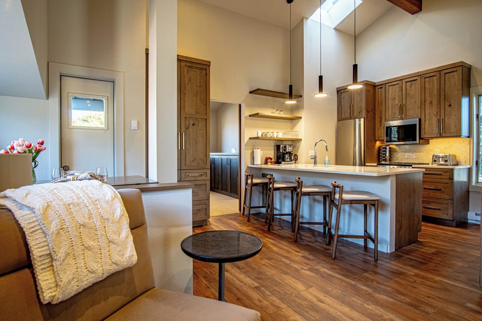 An open floor plan seamlessly connects the dining room, kitchen, and living room, providing a spacious area that comfortably accommodates up to 5 guests