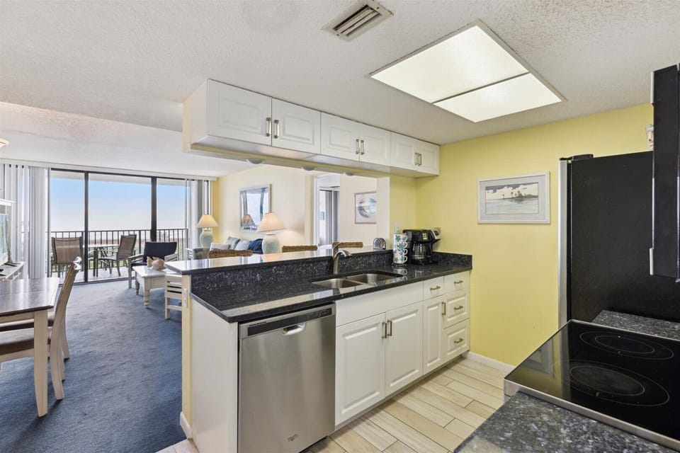 Fully equipped kitchen includes refrigerator, stove, microwave oven. blender and coffee maker.