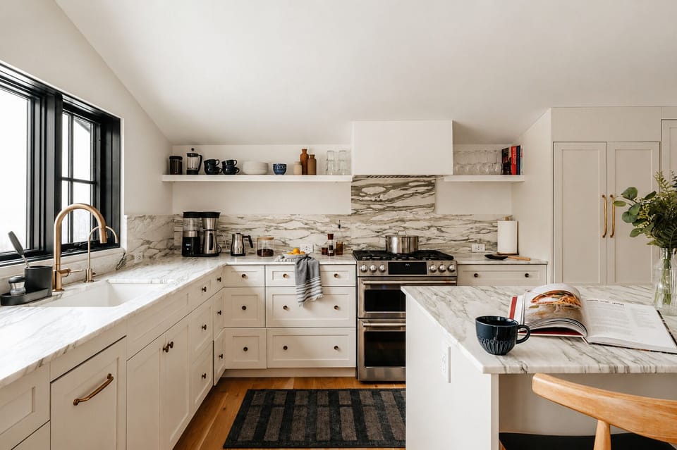 Cook a full meal on the gas range and marble counters, with pots, dishes, and glassware all within reach. The island gives you extra space to prep or set out a spread.