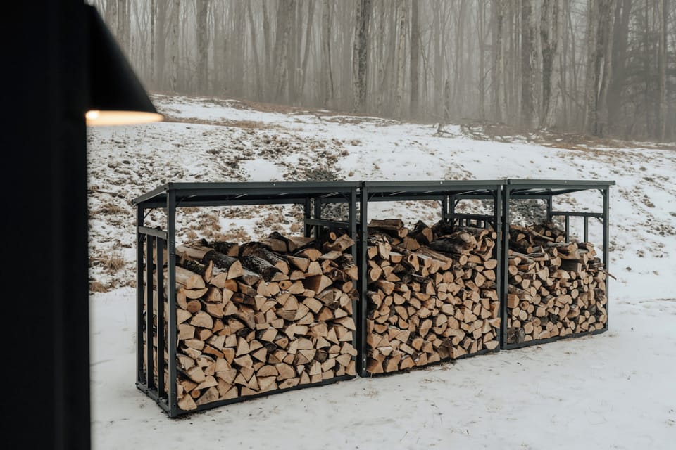 A neatly organized wood shed adds a rustic touch, ensuring cozy nights by the fire remain effortless.