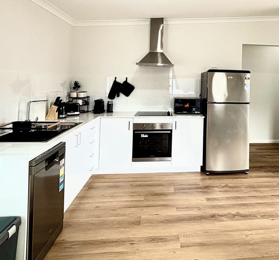 Full kitchen well out fitted for your stay. Full sized fridge, microwave, stove, oven, dishwasher, Nespresso coffee maker, toaster, kettle, and full sets of kitchenware. All part of a spacious open concept kitchen, dining and living space.