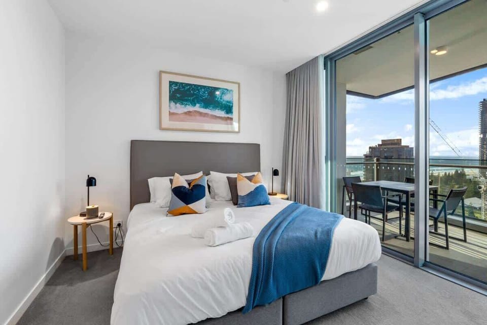 Master Bedroom: Luxurious king bed with two bedside tables for a restful night, Expansive floor-to-ceiling window offering stunning southeast views.