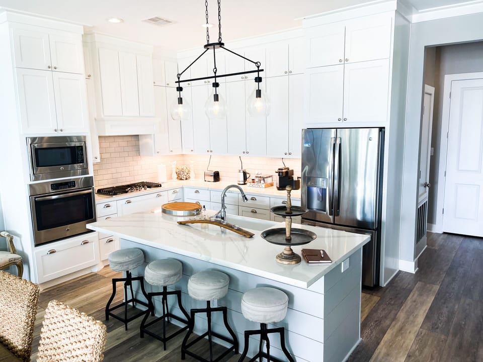 Open gourmet kitchen with bar and four barstools