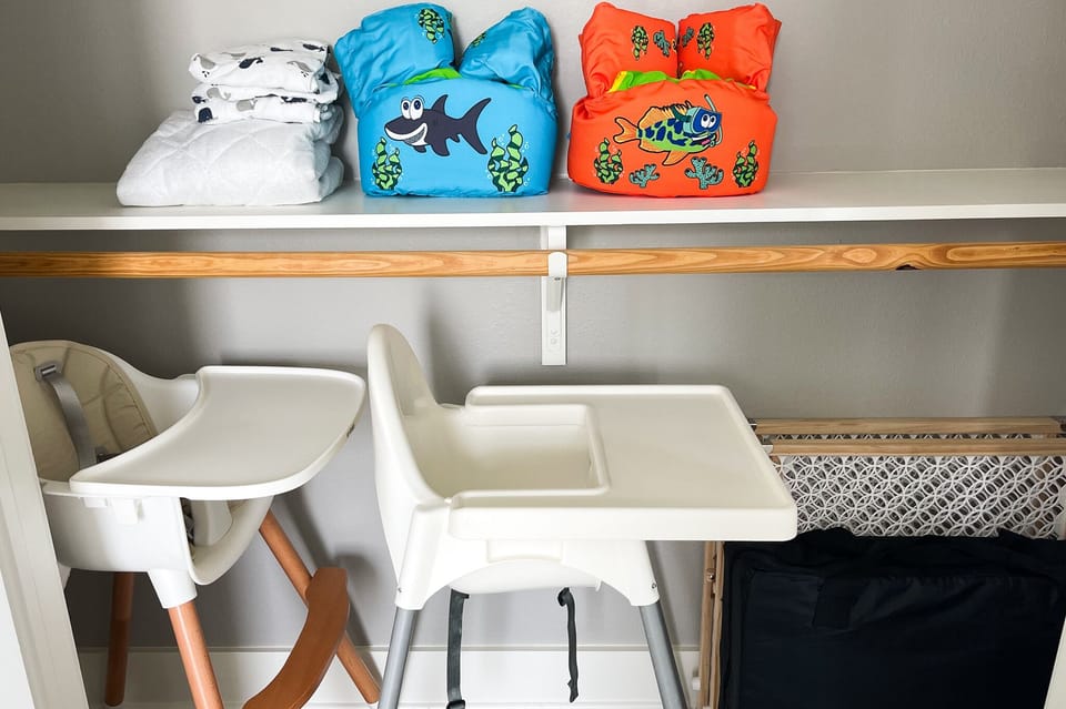 Closet with kids stuff, high chairs, folding bed, safety gates, floaties