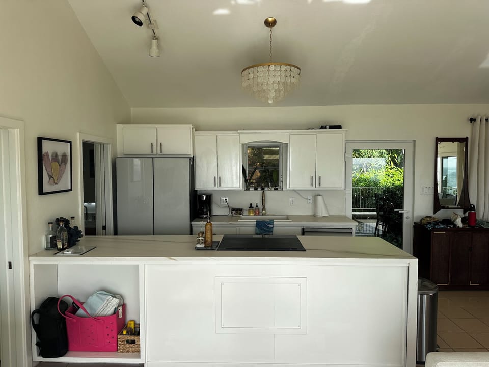Kitchen with full sized refrigerator, dishwasher, and oven range.