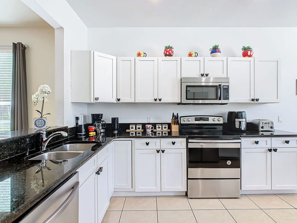 Fully-equipped kitchen with a pass-through window to the dining room