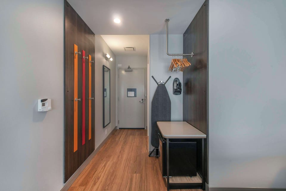 Desk, laptop workspace, blackout drapes, iron/ironing board