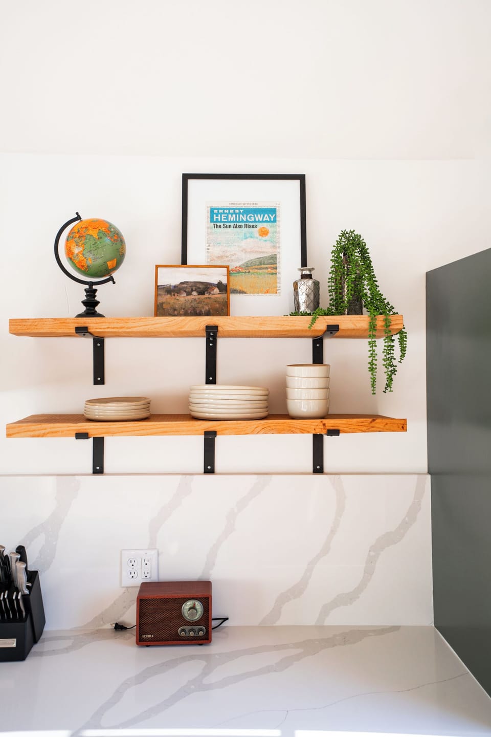 Open shelving detail at Hemingway kitchen — dishware, pantry basics stocked on arrival