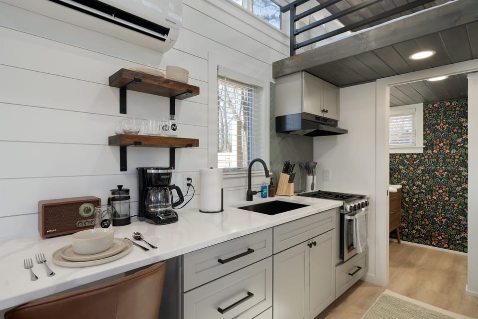 Kitchenette at Hughes — coffee bar, sink, stovetop essentials, and pantry basics stocked on arrival