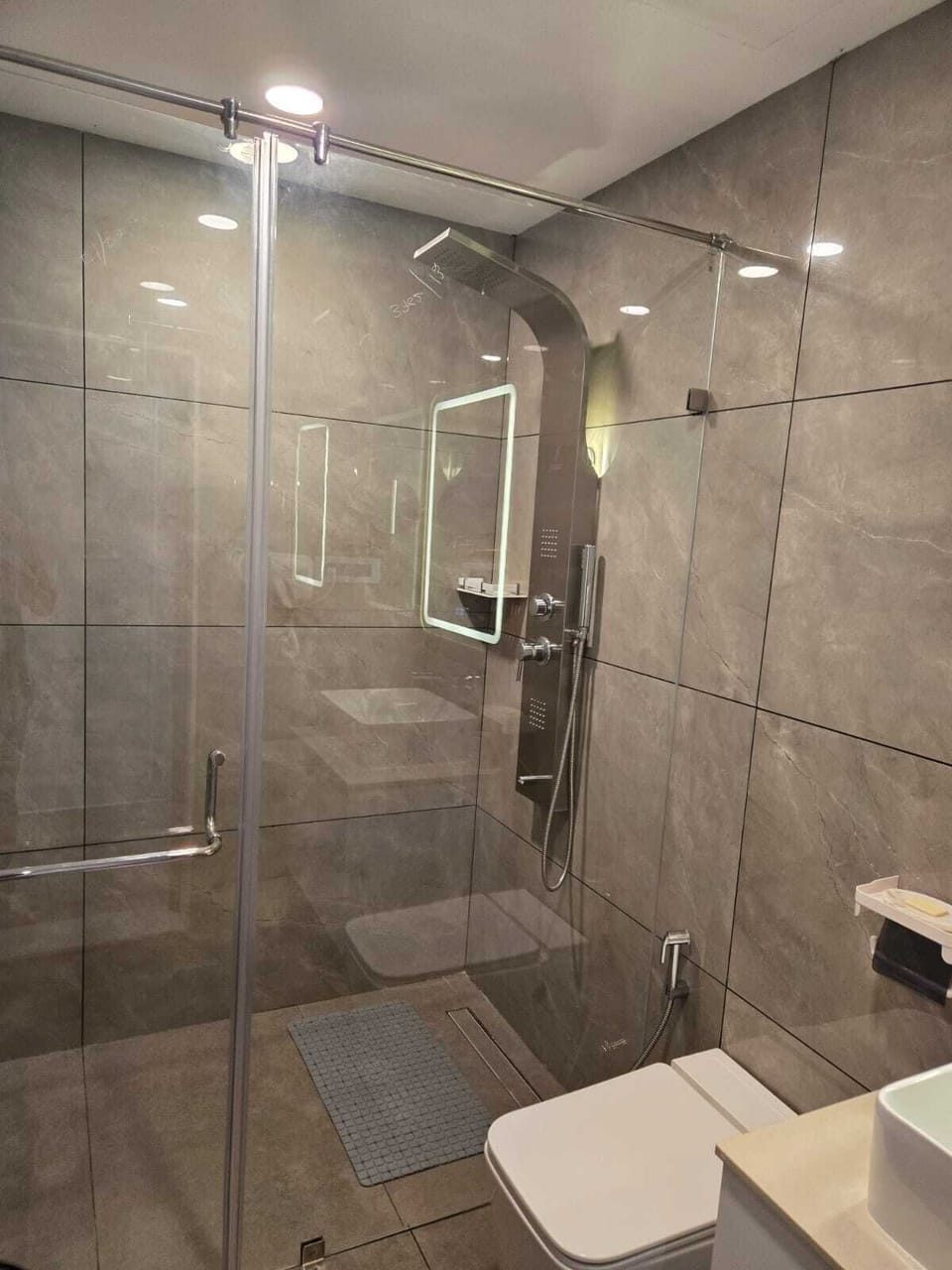 Shower, hair dryer, slippers, towels