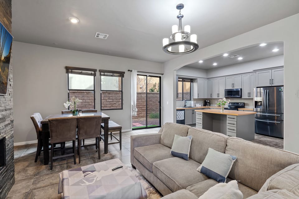 Living room with comfy couch. Dining table with ample seating.