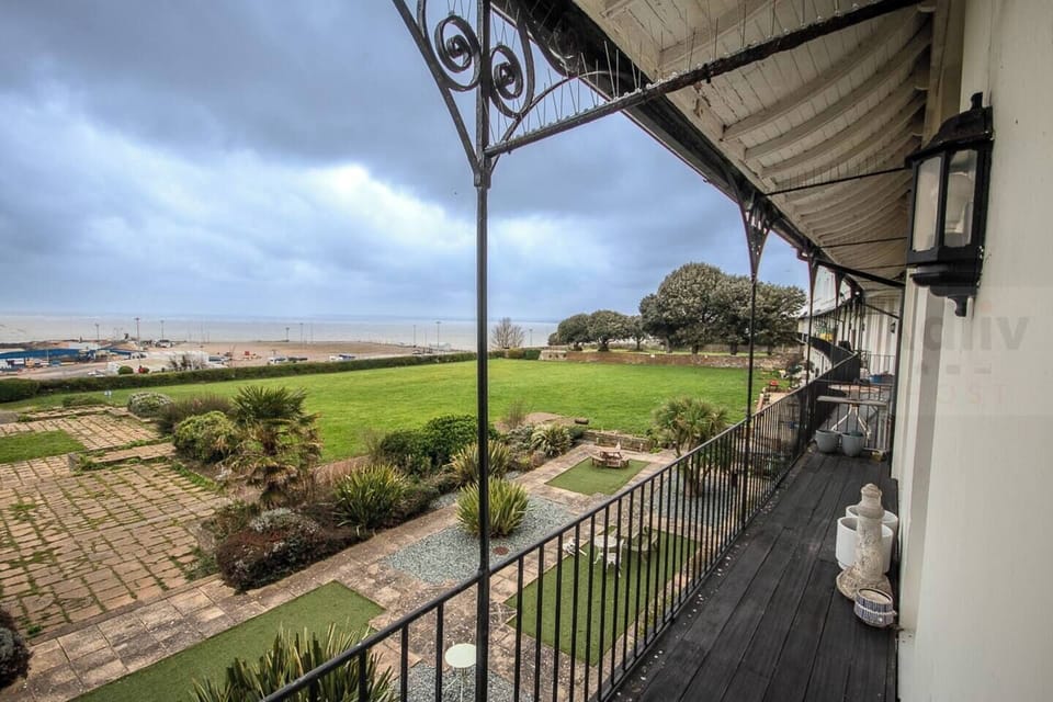 A magnificent private balcony offering panoramic coastal views, where grand period architecture meets the serenity of the shoreline for a truly elevated retreat.