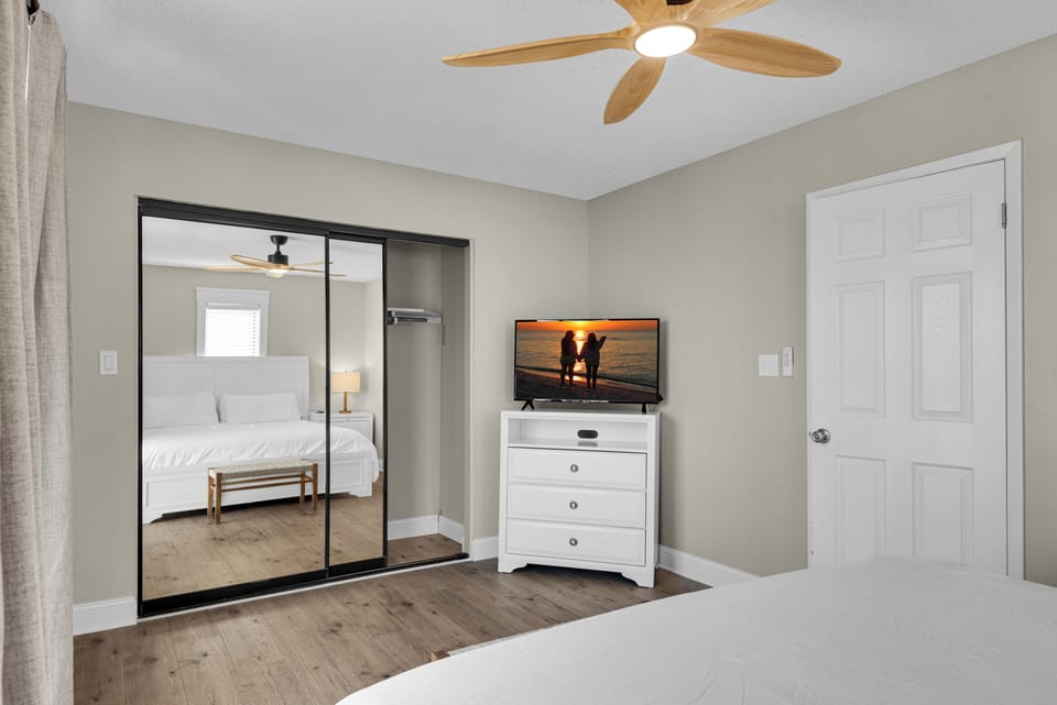 Guest bedroom has a king bed and a flat-screen TV