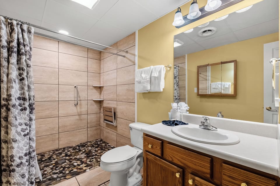 Full bathroom with walk-in shower, towels provided
