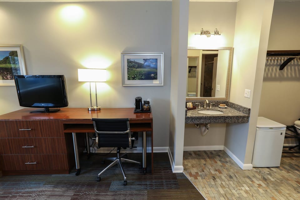 Spacious work area with a desk and modern amenities, perfect for business travelers.